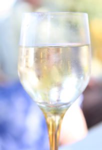 glass of alcohol outdoors in the summer garden, close up with copy space